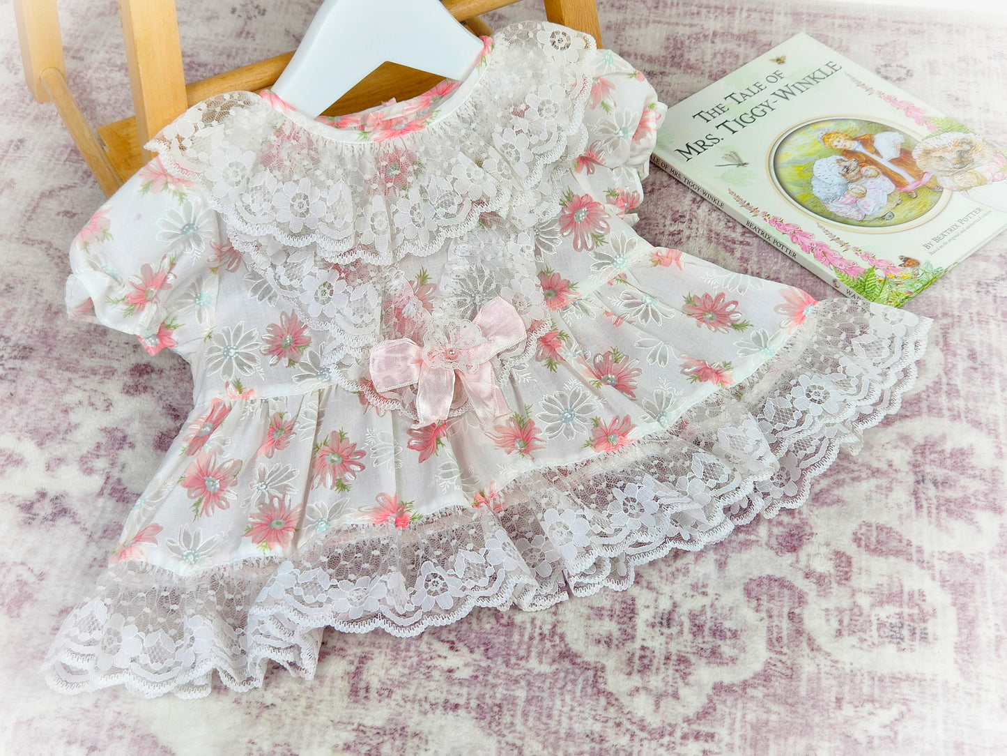 3-6 months. Vintage white sheer dress wkth pink floral print, sating ribbon bow and lace ruffled neck and hem
