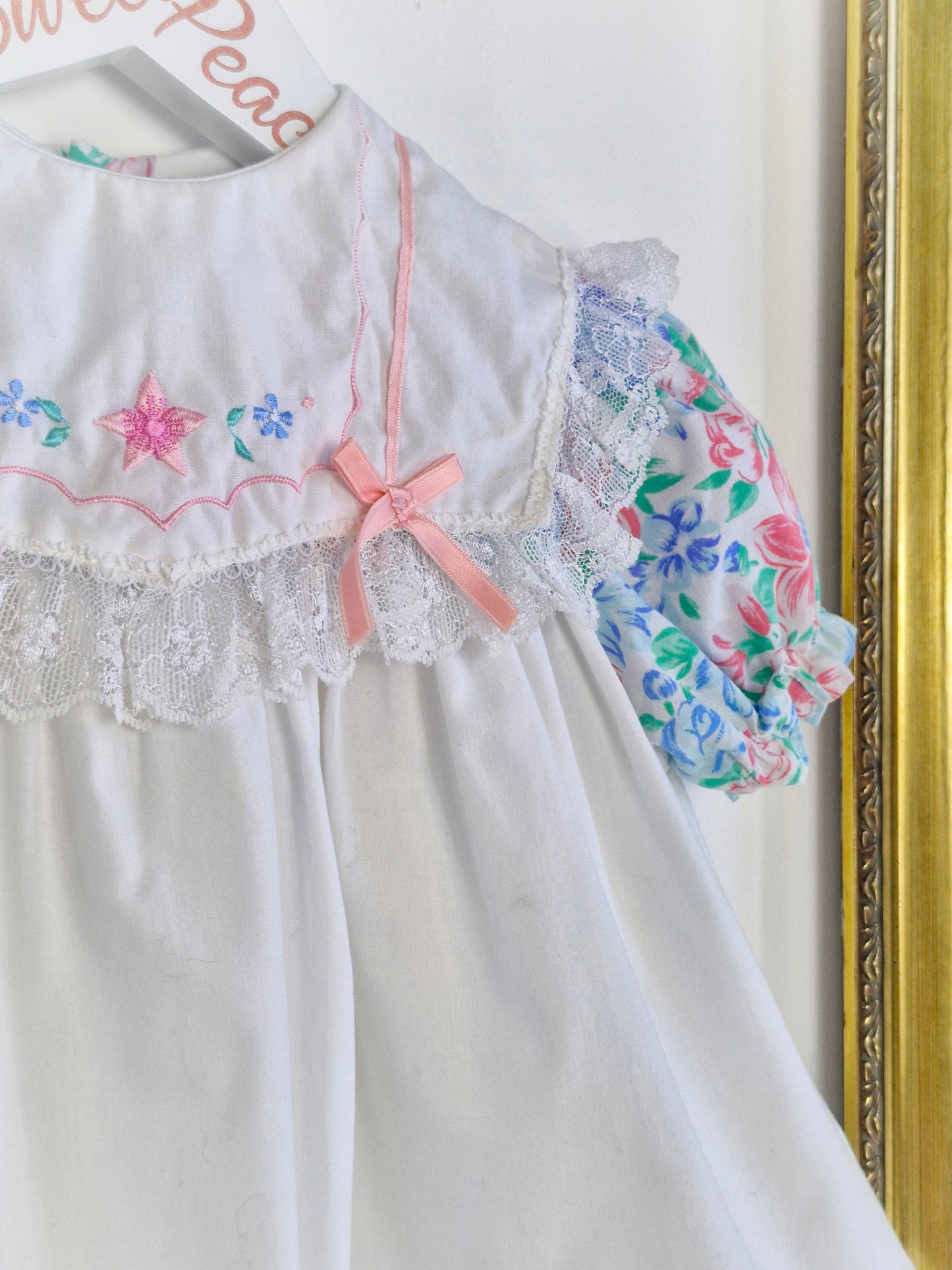 2 years. White dress with floral details and lace. Embroidered bib with ribbon