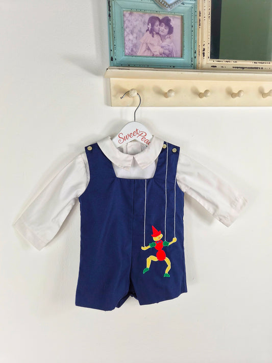 12 months. Two-piece vintage Nannette set, navy short dungarees with white shirt and puppet applique