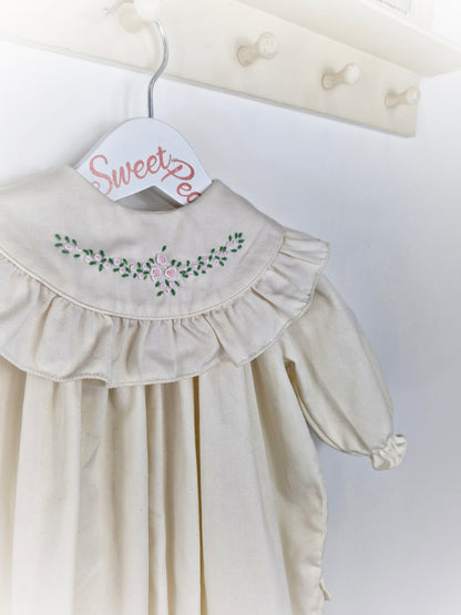 9-12 months Heather Brown romper. Cream with frilly, embroidered bib