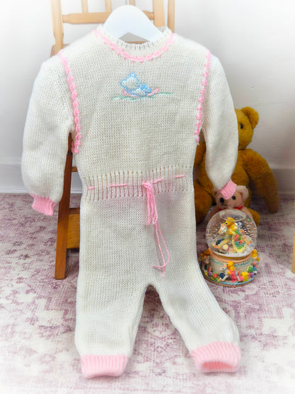 6-12 months. White and pink two-piece knite set