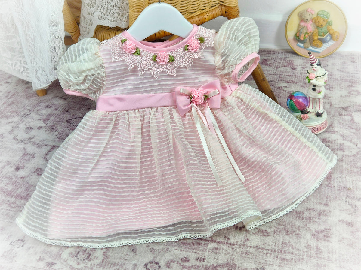 9-12 months. Pink striped vintage taffeta dress with lace collar, pink flowers and belt.