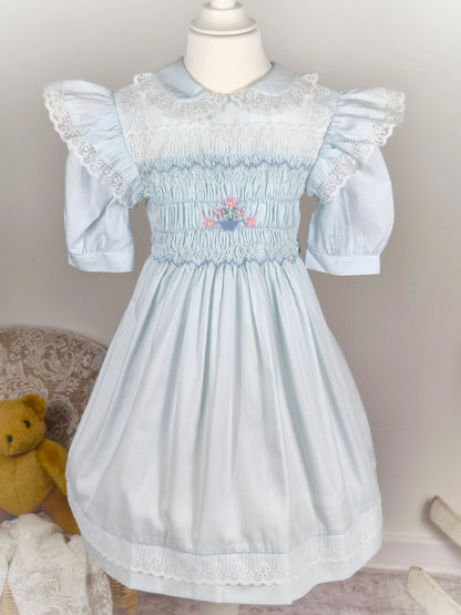 6 years. Blue vintage Polly Flinders smock dress with floral embroidery, lace trim and flutter shoulders