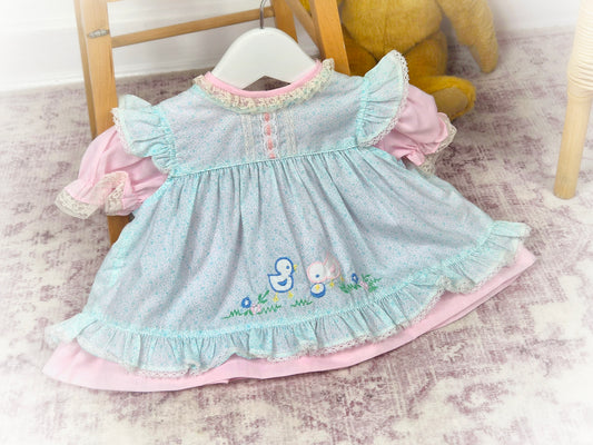 0-6 months. Pink vintage dress with blue apron. Flutter shoulders, embroidered chicks and frill hem