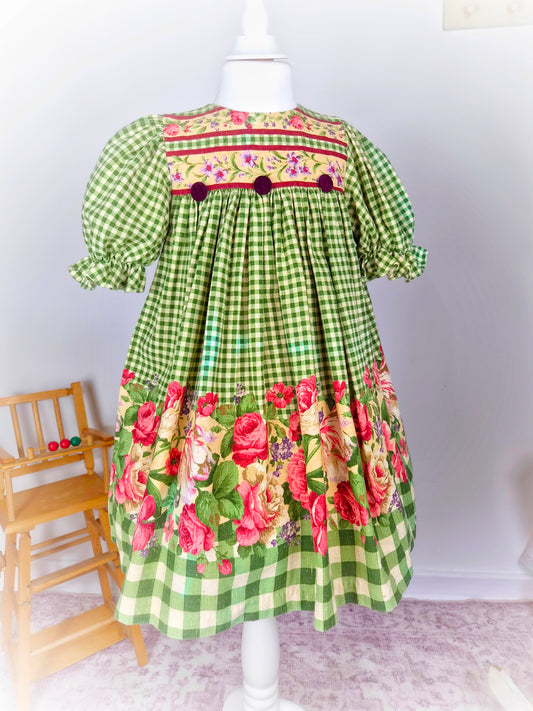 5 years.  Green and cream checked vintage dress with floral print and puff sleeves