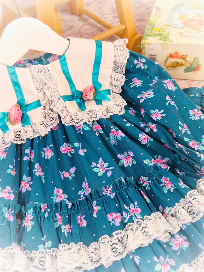 12 months. Teal floral vintage dress with white collar, lace trim, ribbon bows and rosettes