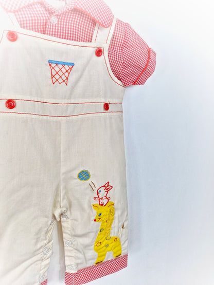 Best fit 6-9 months. Red and white checked romper with animals. Dungaree style