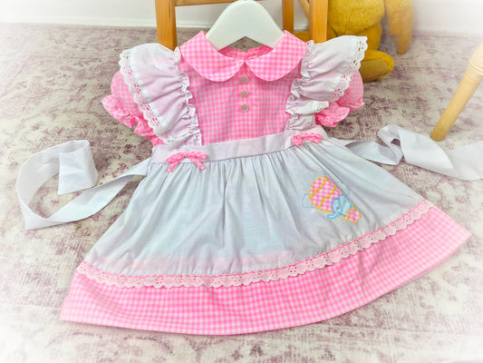 18 months. Pink and white gingham vintage dress with frilly shoulders and cute elephant in a hot air balloon