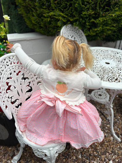 Frilly cream knit bolero with The Sweetest Peach embroidered on the back
