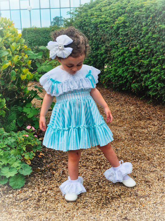 2 years. Mint and white sleeveless, striped dress with white bib, lace and bows