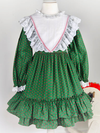 5-6 years. Forest green vintage Bryan prairie dress with red design and white frilly lace bib