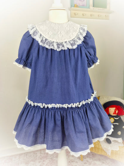 4-5 years. Navy polka dot vintage dress by Special Occasions with white lace bib and trim